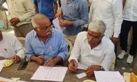 After casting vote, Union Minister Shekhawat makes voters slips outside polling booth