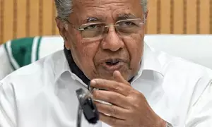 Congress, BJP cry foul over CM Vijayans three nation private trip