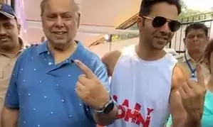 Varun helps his father David Dhawan as they step out to vote in Juhu