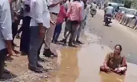 Woman sits in pothole to flag poor condition of roads in Hyderabad