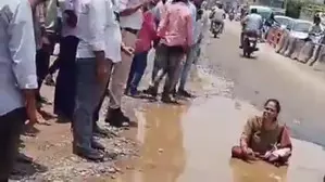 Woman sits in pothole to flag poor condition of roads in Hyderabad