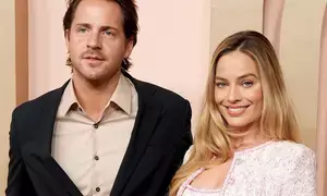 Margot Robbies husband says he spends 24 hours a day with the Barbie star