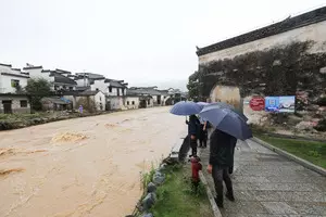Trains suspended, people evacuated as downpours lash China