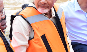 Chandrababu Naidu visits flood-affected Vijayawada in a boat