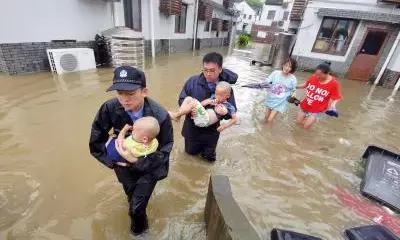 China raises emergency response to floods in Hainan as typhoon rages