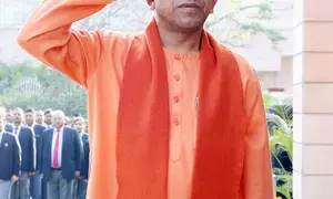 CM Yogi hoists national flag at official residence, extends greetings to citizens