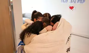 Hamas frees eight hostages in Gaza; Israel delays prisoner release