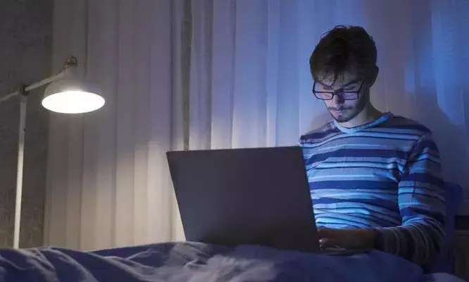 Why using a laptop in bed dangerous while working from home?