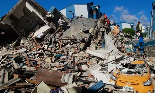 Rescue workers search through rubble of a collapsed building after Colombia’s 7.4-magnitude earthquake in Cali Rescue workers search through rubble of a collapsed building after Colombia’s 7.4-magnitude earthquake in Cali